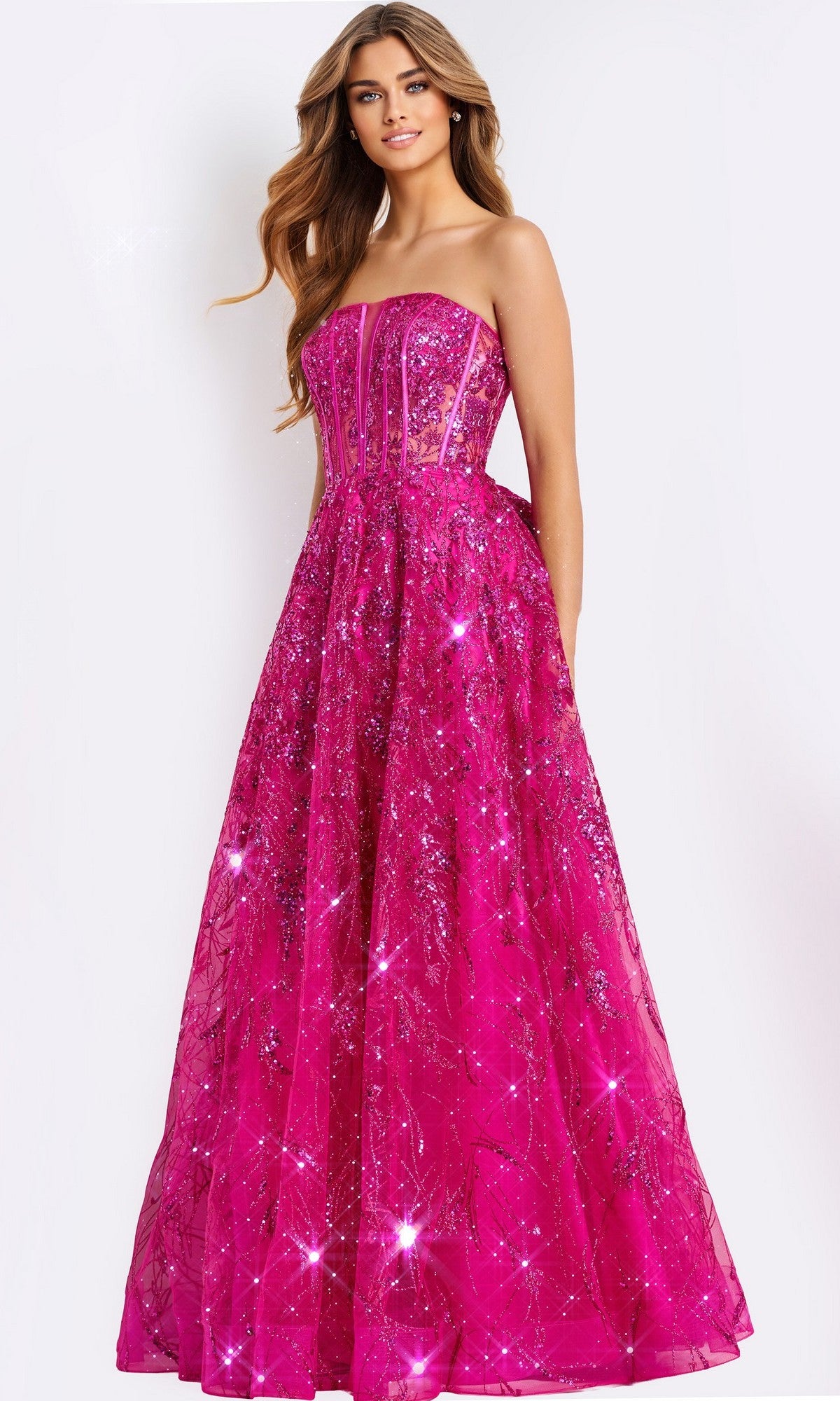 A woman models the Long Prom Dress: Jovani 45913, a strapless bright pink gown with a glittery overlay and fitted semi-sheer corset bodice, posed against a plain white background.